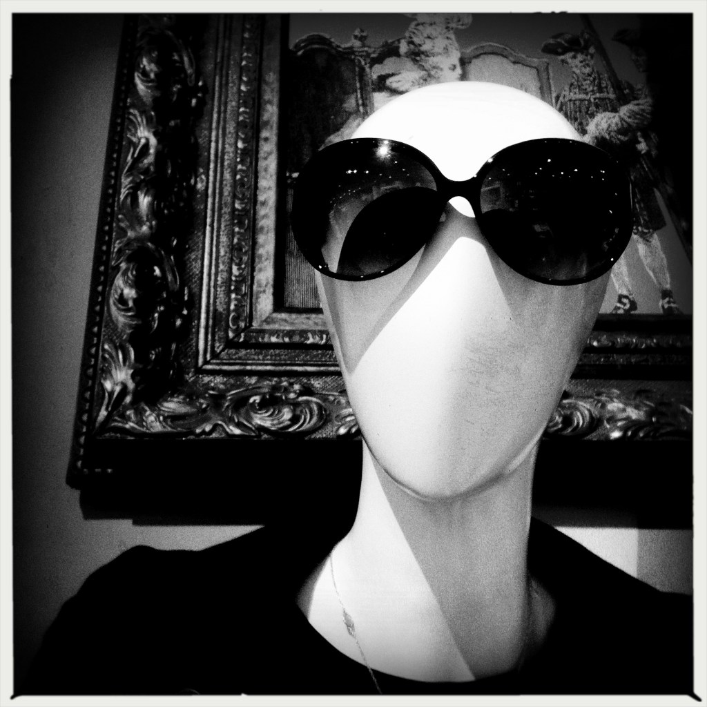 Mannequin's / gaze through dark glasses / disdainful.